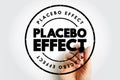 Placebo Effect displayed inside a circular stamp with a hand writing behind it, illustrating psychological response, perception- Royalty Free Stock Photo