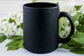 Placeit-Black coffee mug mockup with spring apple blossom Royalty Free Stock Photo