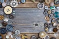 Placer of vintage buttons with copy space on textured old boards