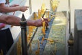 Placing a lighted candle on the altar of Buddha. Royalty Free Stock Photo