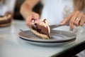 Placing a piece of delicious vegan chocolate cake on a plate Royalty Free Stock Photo