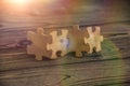 Placing a piece of the puzzle in a row on a textured rustic wooden table Royalty Free Stock Photo