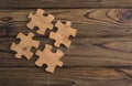 Placing a piece of the puzzle on a textured old wooden table. Royalty Free Stock Photo