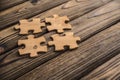 Placing a piece of the puzzle on a textured old wooden table. Royalty Free Stock Photo