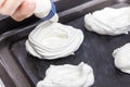 Placing and shapping meringues on a baking sheet