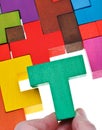 Placing T-shaped piece in wooden puzzle Royalty Free Stock Photo