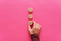 Placing three wooden cut circles wit contact and information icons on them over pink background Royalty Free Stock Photo