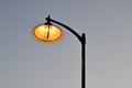 A plafond of a street lamp with a lit light bulb Royalty Free Stock Photo