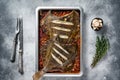 Plaice or Flounder flat fish baked in a tomato sauce in baking tray. White background. Top view