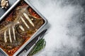 Plaice or Flounder flat fish baked in a tomato sauce in baking tray. White background. Top view. Copy space