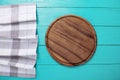 Plaid tablecloth, brown cutting board for pizza on blue wooden table. Wood background. Top view and mock up.Copy space Royalty Free Stock Photo