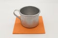 Plain aluminum mug on an orange napkin Royalty Free Stock Photo