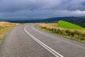 Plain asphalt road turning right through Adelaide Hills farms