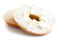 Plain bagel cut in half and spread with cream cheese. Isolated o