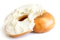 Plain bagel spread with cream cheese and bite missing. Isolated.