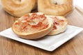 A plain bagel with strawberry jelly