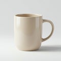 A plain beige ceramic mug with a glossy finish, featuring a rounded body and a single Royalty Free Stock Photo