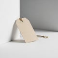 A plain beige paper tag is leaning against a white rectangular Royalty Free Stock Photo