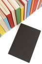 Plain black book front cover with row of colorful books isolated on white background Royalty Free Stock Photo