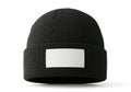 A plain black knitted beanie with a blank white rectangular patch on the front isolated on white background Royalty Free Stock Photo