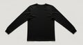 Plain black long sleeve t shirt laid flat against a light gray background Royalty Free Stock Photo