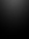 A plain black textured background with a subtle gradient and a soft spotlight effect in the upper center, minimalist Keywords: Royalty Free Stock Photo