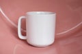 Plain blank white 11oz cup in front of a pink shiny surface Royalty Free Stock Photo