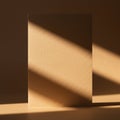A plain brown cardboard sheet is illuminated by soft, diagonal sunlight, casting Royalty Free Stock Photo