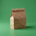 A plain brown paper bag with a folded top sits on a green background. The bag has a Royalty Free Stock Photo
