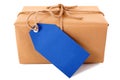 Plain brown paper package or parcel, blue gift tag or address label, isolated, front view Royalty Free Stock Photo