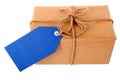 Plain brown paper package or parcel, blue gift tag or label, isolated on white Royalty Free Stock Photo