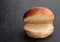 Plain burger bun on black stone background