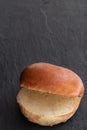 Plain burger bun on black stone background Royalty Free Stock Photo