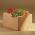A plain cardboard box against a neutral background. On top, there are leaves with a Royalty Free Stock Photo