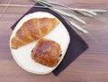 Plain and Chocolate croissant on wooden board and rustic background Royalty Free Stock Photo