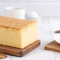 Plain classic Taiwanese traditional sponge cake Taiwanese castella kasutera on a wooden tray background table with ingredients, Royalty Free Stock Photo