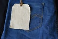 Plain clothing tag on jeans background