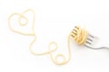 Plain cooked spaghetti pasta on fork with heart shape, on white background. Royalty Free Stock Photo