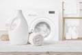 Plain detergent bottle on wood over defocused laundry room interior