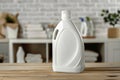 Plain detergent bottle on wood over defocused laundry room interior for product display Royalty Free Stock Photo