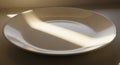 A plain, empty white plate sits Royalty Free Stock Photo