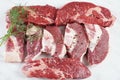 Plain fresh beef cut chuck steak and raw steaks with bone on cutting board prepared for cooking Royalty Free Stock Photo