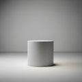 Plain, gray cylindrical object is centered on a flat surface with a neutral Royalty Free Stock Photo