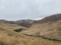 Plain landscape and hills covered with golden grass Royalty Free Stock Photo