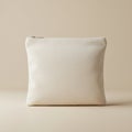 A plain, light beige fabric pouch with a zipper on top is displayed against a matching Royalty Free Stock Photo