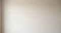 A plain, light beige wall with a smooth, slightly textured surface is visible. There are Royalty Free Stock Photo