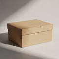 A plain, light brown cardboard box with a fitted lid sits on a surface, casting a shadow Royalty Free Stock Photo