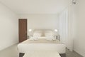 Plain light colored bedroom with large double bed in a vacation rental apartment Royalty Free Stock Photo