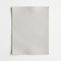 A plain, light gray piece of paper with a slightly textured surface is centered against a white Royalty Free Stock Photo