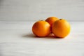 Plain orange mandarins on a grey background